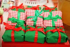 several wrapped presents sitting on top of a red box