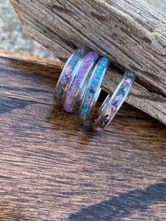 These rings are a great way to memorialize passed loved ones or pets by inlaying cremation ashes or locks of hair behind the inlay material. They can also be used as one of a kind wedding bands, school sprit rings, birthday rings. There are many colors and materials to chose from. Ring cores can be metal (silver or black) or exotic wood (wenge, Koa, Whiskey barrel, or Bocote) Inlay material can consist of opal, gemstones, mother of pearl or a number of materials. Price as stated is base price wh Round Rings With Inlay Perfect For Gifts, Gift Round Ring With Inlay, Sterling Silver Keepsake Rings, Unique Silver Ring For Memorial, Silver Keepsake Ring, Anniversary Opal Ring With Natural Inclusions, Angel Wings Wall Decor, Ash Jewelry, Memorial Jewelry Ashes