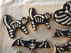 decorated cookies with black and white icing on a table