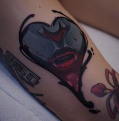 a close up of a person's leg with a tattoo on it and the image of a woman's face