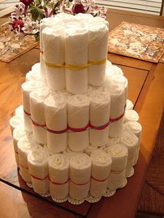 there is a large cake made out of rolls of toilet paper on top of the table