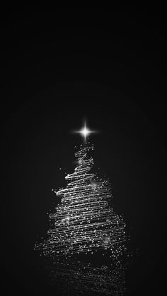 a black and white photo of a christmas tree with a star on it's top