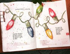 an open book with christmas lights drawn on it's pages and attached to clips