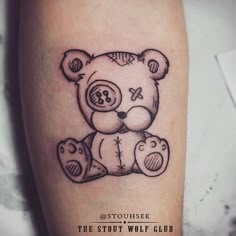 a black and white tattoo of a teddy bear