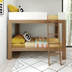 there is a bunk bed with a ladder on the bottom and yellow pillows on top