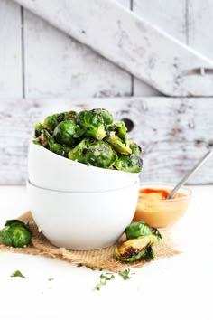 two white bowls filled with brussel sprouts