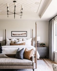 a bedroom with a canopy bed and pillows