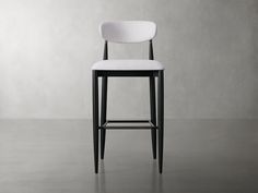 a black and white bar stool against a gray wall