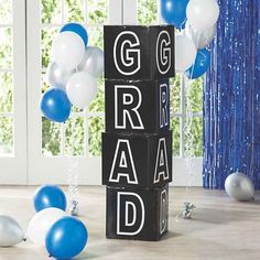 blocks spelling congratulations surrounded by balloons and streamers