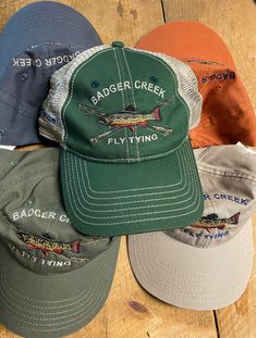 These are stitched hats from Camp David in Kansas. These feature a NY State Brook Trout rod with crossed rods. Choose from: Tan, Steel Blue, Sage, Burnt Orange and Mesh with Olive. Fully adjustable with Velcro tab. Casual Cotton Fishing Hat, Casual Adjustable Snapback Hat For Fishing, Spring Fishing Hats With Curved Brim, Spring Fishing Hat With Curved Brim, Casual Curved Brim Trucker Hat For Fishing, Casual Short Brim Trucker Hat For Fishing, Casual Short Brim Baseball Cap For Fishing, Casual Snapback Hat For Fishing, Curved Brim Fishing Hat