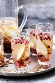 three glasses filled with liquid sitting on top of a plate