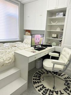 a bedroom with a bed, desk and chair next to a book shelf filled with books