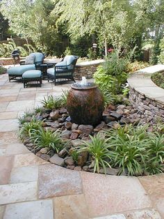 an outdoor patio area with chairs and a fire hydrant in the middle of it