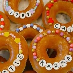 there are many donuts decorated with letters and candy on the doughnuts that spell out their name