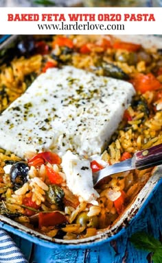 baked feta with orzo pasta in a blue casserole dish