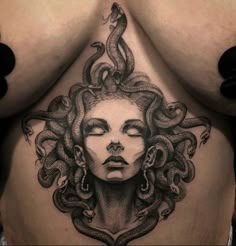 a woman's stomach with an intricate tattoo design on the side and her face surrounded by snakes