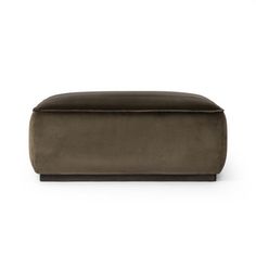 the foot stool is made from dark brown velvet