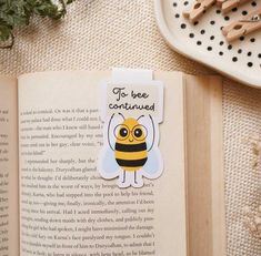 an open book with a bee sticker on it