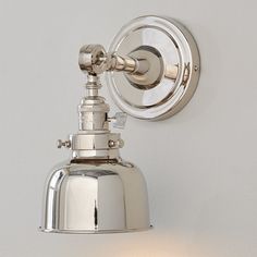 a chrome wall light on a white wall