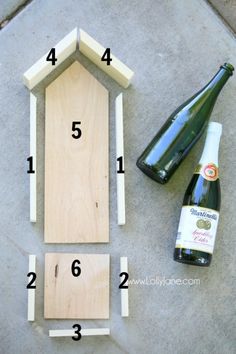 the steps to make a birdhouse with wood and glue are shown next to a bottle of wine