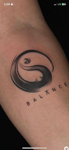 a woman's arm with a tattoo on it that says balance in black ink