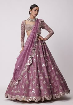 Step into a world of elegance and grace with our lilac sequins and mirror lehenga. This stunning lilac lehenga is crafted from organza and features mesmerizing mirror and sequin embroidery. Teamed with a full-sleeve blouse adorned with hand-cut mirrors and a dupatta that features an embroidered scallop border. Perfect for the bride or bride-to-be, this lehenga set is sure to make a statement on your special day. Embrace your inner goddess and shine bright in this exquisite ensemble, capturing the essence of elegance and timeless beauty. Composition : Lehenga - Organza, Dupatta - Organza, Blouse - Georgette Care: Dry Clean Only and Vacuum Storage This product can be customized for sleeves, length and colour Delivery : 6-8 weeks as the product is hand crafted. Check Size Guide or choose MySi Lilac Lehenga, Sequin Lehenga, Purple Lehenga, Vani Vats, Lehenga Pattern, Embroidery Mirror, Organza Embroidery, Full Sleeve Blouse