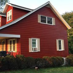 a red house with white trim and windows