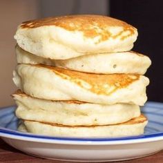 a stack of pancakes sitting on top of a blue and white plate