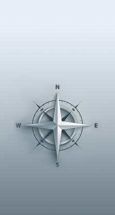 a white compass on a gray background with the letter n in it's center