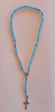 "Personalized boys rosary with blue beads. Send us a note in \"Add your personalization\" tab with the name or initials you want on rosary. As well as any other request. You can put rosary on neck and has a clasp so it will fit adults, teens and kids a like. Handwoven by our family in Medjugorje. Centerpiece and cross is Saint Benedict. Rosary lenght is 42 cm (16.5 inches) Beads size is 8 mm. Each rosary is made to order specially for you. Very light and can be worn in any occasion. Specially gr Blue Spiritual Rosary As A Gift, Blue Rosary With Round Beads For Gift, Blue Cross Rosary For Gift, Blue Cross Rosary As Gift, Blue Beaded Rosary As A Gift, Adjustable Blue Rosary With 8mm Beads, Handmade Blue Rosary With Cross Shape, Handmade Blue Rosary With Cross, Spiritual Blue Rosary With 108 Beads