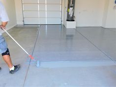 a man using a mop to clean a garage floor