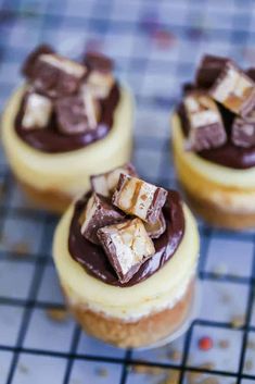 small desserts with chocolate and marshmallow toppings on a blue checkered tablecloth