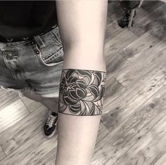 a person with a black and white tattoo on their arm