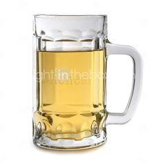 a glass mug filled with liquid on top of a white table