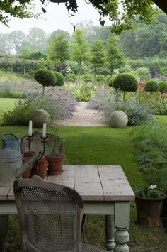 a table and chairs in the middle of a garden