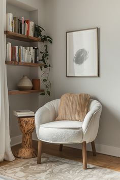 a white chair sitting in front of a book shelf