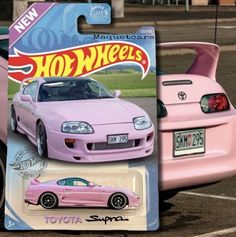 the hot wheels pink car is parked next to another toy car in a parking lot