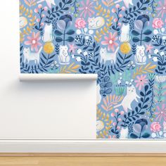 a wallpaper with flowers and cats on it, next to a white door frame