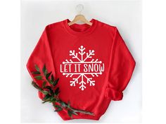 "Let it Snow Sweatshirt Hoodie, Let it Snow Shirt, Christmas Shirt, Christmas Gifts, Winter Sweatshirts, Christmas Hoodies, Christmas Sweater ----------- How to Order Your Custom Design T-shirt ---------- * Choose your t-shirt color * Choose your size * PLEASE make sure all your order's steps ---------- Product ---------- * 4.2 oz., 100% airlume combed and ringspun cotton, 32 singles * 32 singles Athletic Heather and Black Heather are 90/10 airlume combed and ringspun cotton/polyester Ash is 99/1 airlume combed and ringspun cotton/polyester * double-needle stitching throughout * seamless collar * heat transfer label * taped shoulder-to-shoulder Tell us what you want in the Message Box that's hidden in the Review Page during Checkout. Please use \"ADD MESSAGE TO SELLER\" icon before you che Elf Sweatshirt, Family Sweater, Elf Sweater, Santa Sweatshirt, New Years Shirts, Merry Christmas Shirts, Sweatshirt For Women, Women Christmas, Christmas Hoodies