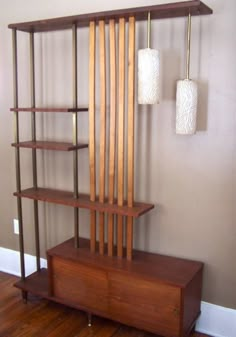 a wooden shelf with two lamps hanging from it