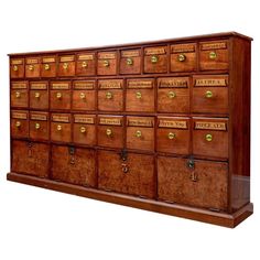 an old wooden cabinet with many drawers and brass knobs on the front, isolated against a white background