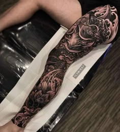 a man's leg with tattoos on it