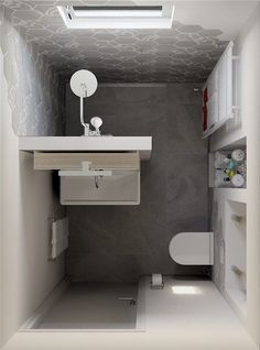 a small bathroom with a toilet, sink and mirror in the corner on the wall