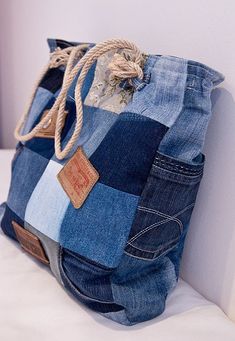 a bag made out of jeans hanging on a wall