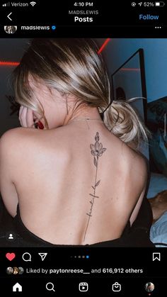 the back of a woman's neck with flowers tattooed on her upper and lower back