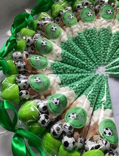 an arrangement of green and white candies with soccer balls on them