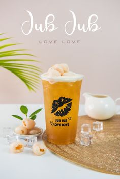 a cup filled with ice cream sitting on top of a table next to some glasses