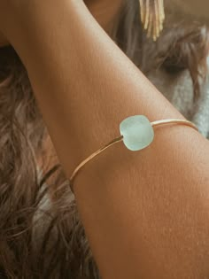 This Seaglass Banle is crafted from beautiful gold filled metal and features a round light blue sea glass bead. With its size of 6,7, or 8” this bangle is perfect for all wrist sizes. It's an eye-catching piece sure to make a statement. Recycled Glass Round Beads Jewelry For Gifts, Recycled Glass Round Beads Jewelry Gift, Beach Glass Bracelet Jewelry, Minimalist Recycled Glass Jewelry For Gifts, Jewelry Blue, Gold Glass Bracelets, Turquoise Bangle For Everyday Wear, Everyday Round Glass Jewelry, Glass Bangle Jewelry Gift