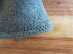 a close up of a hat on a wooden surface