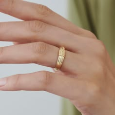 a woman's hand with a gold ring on it